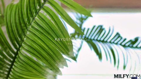Kayden Kross Milfy.com promotional image with lush green fern leaves overlay
