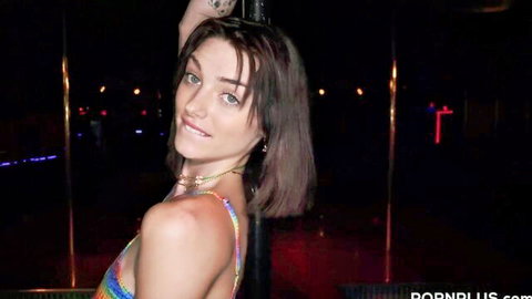 Skinny brunette teen stripper exposes small tits teasing on pole in neon club