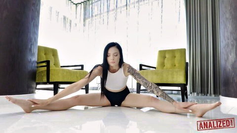 Marley Brinx flexible wide split in white tank top and black shorts