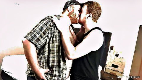 Two bearded tattooed men sharing a passionate kiss in intimate embrace