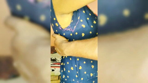 South Asian man's hand pulls down Indian woman's blue polka-dot top exposing her cleavage and tits