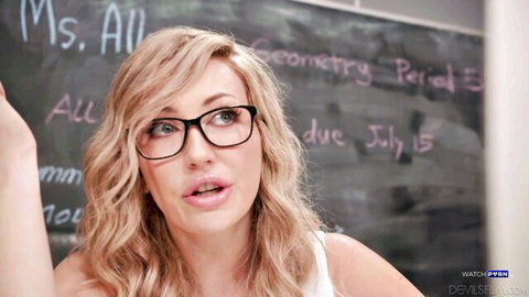Adira Allure as sexy blonde teacher in glasses, seductive classroom pose