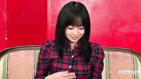 Cute skinny Japanese babe with small natural tits smiling in plaid shirt on sofa