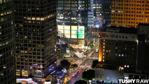 Stunning nighttime aerial cityscape of skyscrapers, streets and lights from high-rise window