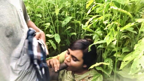 South Asian girl kneels in lush green field sucking thick cock outdoors passionately
