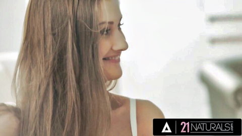 Tiffany Tatum smiling seductively in white top, long hair flowing