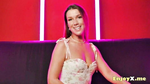 Alexis Crystal smiling in low-cut floral dress with cleavage