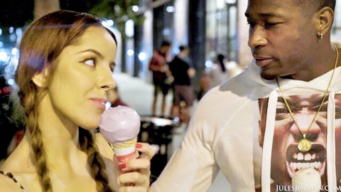 Brunette with pigtails licks purple ice cream cone seductively teasing black stud on urban night street