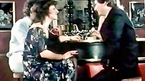 Vintage retro MILFs in dresses tease cocks under table in clothed foursome bar scene