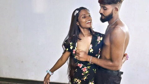 Sexy Indian babe in floral dress flashing deep cleavage hugged by shirtless muscular hunk