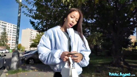 Lia Lin in casual outfit checks phone outdoors for public agent cash scene