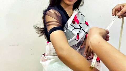 Sexy Indian woman in floral saree getting arm measured teasingly