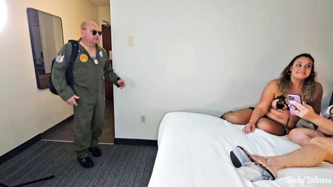 BBW with massive bare tits sits spread-legged on hotel bed taking selfie with pilot guy and lingerie girl