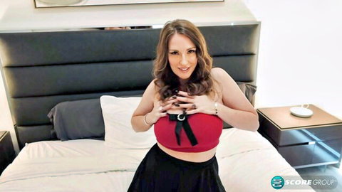 Curvy brunette squeezing huge tits in red bow bra and black mini skirt on bed