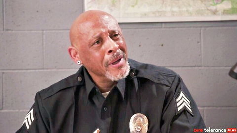 Bald black cop in uniform stares intensely in Rebel Rhyder adult roleplay thumbnail