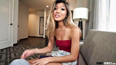 Clara Trinity, sexy Asian babe in red tube top and shorts, smiling playfully