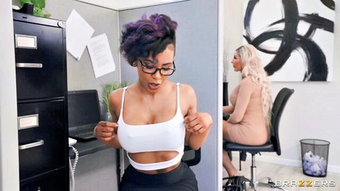 Ebony babe in glasses pulls open white top exposing perky tits in office cubicle with blonde coworker
