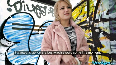 Blonde in pink fur coat waiting for bus at graffiti wall in Public Agent pickup
