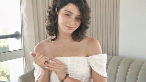 Bonnie Eversley teases in white off-shoulder dress on webcam