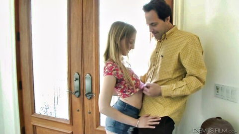 Riley Reyes in floral crop top and denim shorts teases husband near door