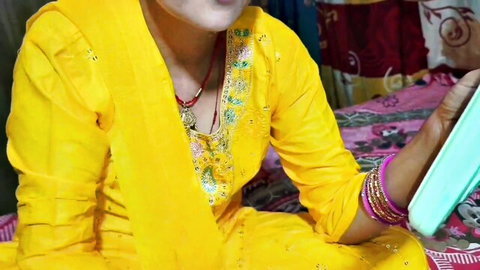 Desi Indian maid in yellow salwar kameez with bangles and necklace, teasing with Hindi dirty talk