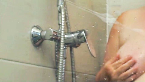 Wet nude mature BBW with huge tits squeezing her massive breasts in steamy shower
