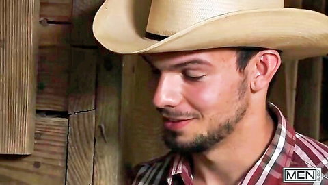 Handsome gay cowboy hunk smiling seductively in hat and plaid shirt closeup
