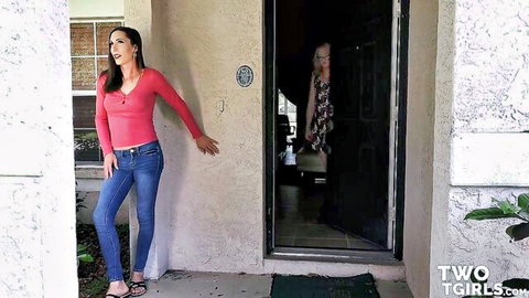 Sexy brunette babe in pink top and tight jeans teasing at door with girl inside