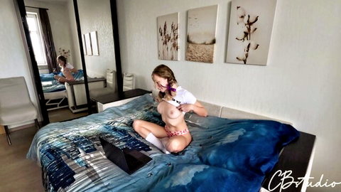 Blonde stepdaughter in pigtails masturbates topless on bed with laptop