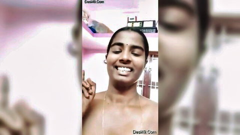 Topless smiling Indian woman with perky brown tits making peace sign in homemade selfie