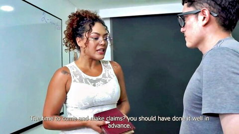 Ebony teacher Carla Morelli in lace top chatting with student in class