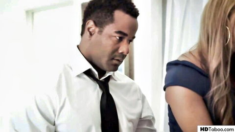 Black suited man intensely stares at blonde woman in off-shoulder blue dress interracial taboo tension