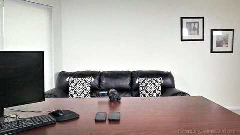 Empty backroom casting couch studio with black leather sofa and desk ready for babe auditions and fucking