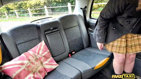 Red August bends over in plaid skirt outside Fake Taxi cab