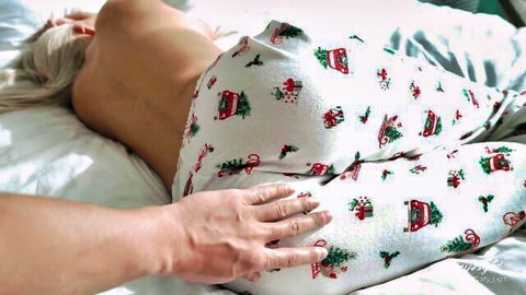 Blonde stepmom topless in festive Christmas pajamas, hand groping her ass on bed
