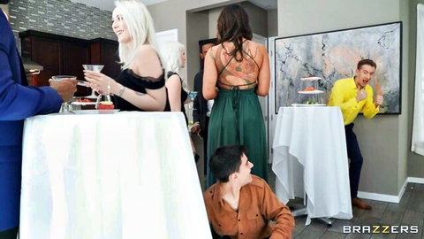 Sexy blonde and brunette in tight dresses flirt with suited men at Brazzers party.