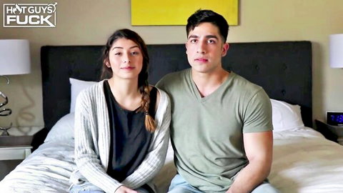Mexican nubile and Latino jock couple on bed, intense gaze