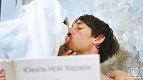Fair-skinned brunette stepmom in white towel passionately kisses young stepson on lips