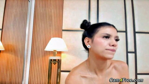 Petite Asian babe topless, sultry gaze in solo tease