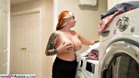 Tattooed redhead with huge bouncy tits topless bending over washer doing laundry