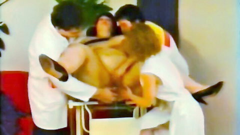 Naked brunette MILF spread eagle on medical table groped by doctors and nurses