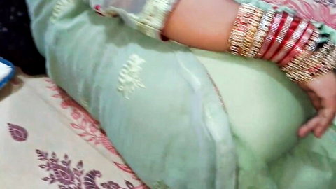Indian newlywed in green saree poses seductively on bed, wild beach break tease