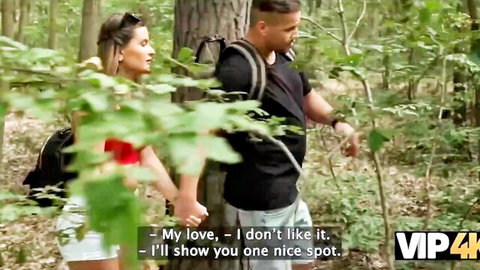 Brunette in red top and shorts hikes hand-in-hand with man in mountains cuckold tease