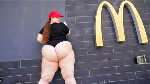 Thick ginger babe in red cap bends over showing massive fat ass cheeks in black thong at McDonald's