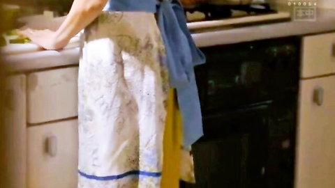 Brunette MILF in floral apron bending over kitchen counter teasing