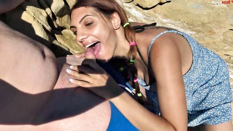 Brunette with ponytails gives sloppy blowjob to huge cock on rocky beach