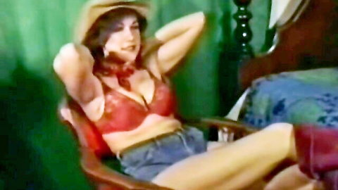 Busty retro cowgirl in red lingerie and shorts, seductive pose in bedroom roleplay