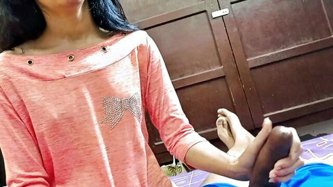 Desi Indian woman in pink top grips man's foot near erect cock