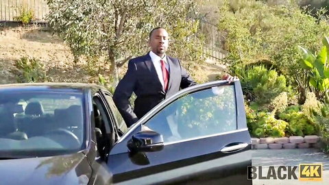 Suited black man opens car door in interracial setup tease