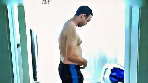 Shirtless Noel Sur pulling down shorts in surprise anal encounter